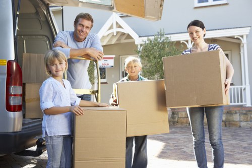 Professional movers handling boxes and furniture for a home relocation
