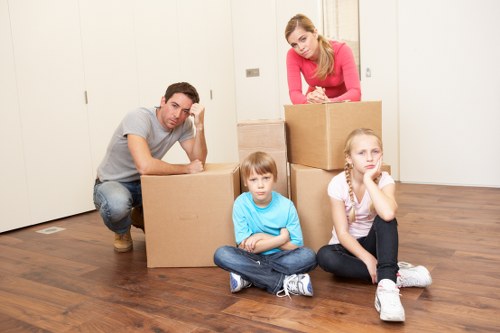 Business movers handling desks and equipment for a Lee office move