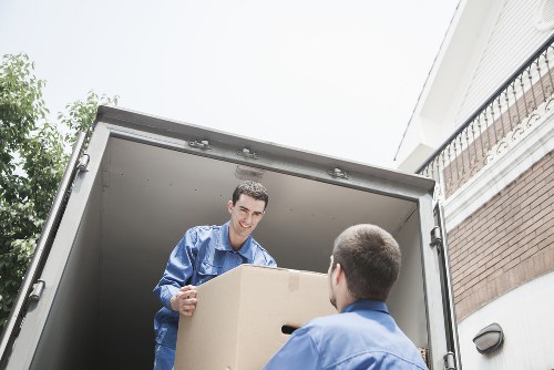 Local moving team loading boxes into a van in Lee