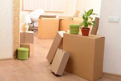 Movers carrying furniture from a home in Lee