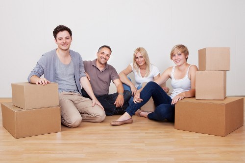 Loading furniture into a moving truck on a residential street in Lee