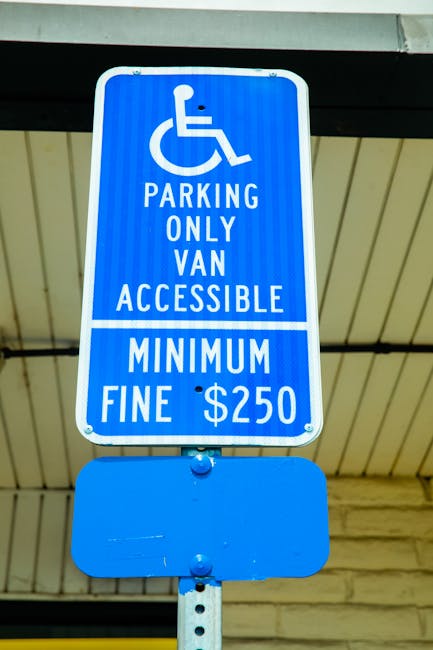 A rectangular metal sign mounted on a stone wall, displaying the message 'PARKING WITH HOTEL PERMIT ONLY' in bold black letters on a white background with a thin black border. The wall is composed of