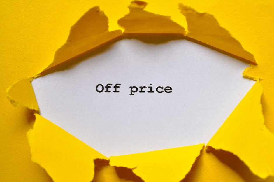 A close-up of a torn yellow paper revealing a white paper underneath with the words 'Off price' typed in black, indicating a discounted or reduced cost. The torn edges of the yellow paper suggest it was intentionally ripped, creating a jagged border around the white paper. The background is yellow, matching the torn paper, and the scene appears to be inside a property or in a setup related to house removals or packing. Visible parts of the torn paper and the focus on the phrase imply a connection to affordable or discounted moving services, as offered by [COMPANY_NAME], which specialises in removals and home relocation logistics.